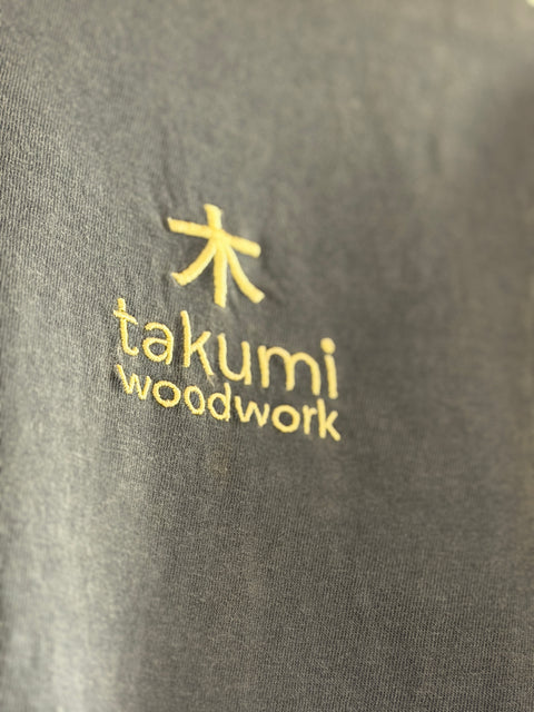 Gold Takumi embroidery detail on denim navy fabric